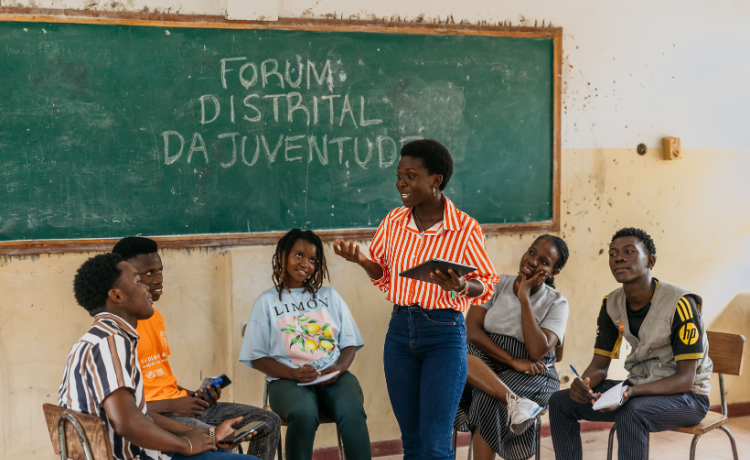 A group of young people in a classroom discussing solutions for climate resilience. 