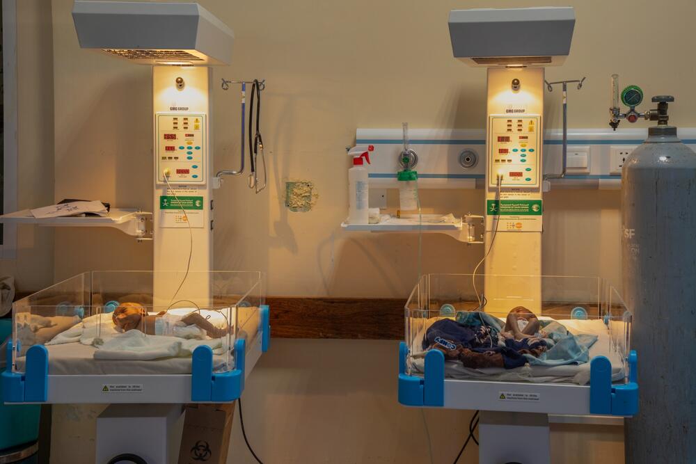 Two premature babies are inside incubators. 