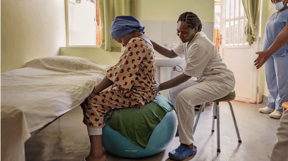 Midwife checks on patient.