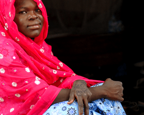 Young woman in Cameroon A young woman in bright pink headscarf.