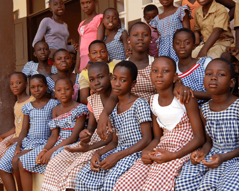 Schoolgirls in Cote d'Ivoire Girls sit outside their school.