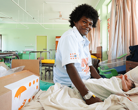A woman with her newborn daughter in a health clinic.