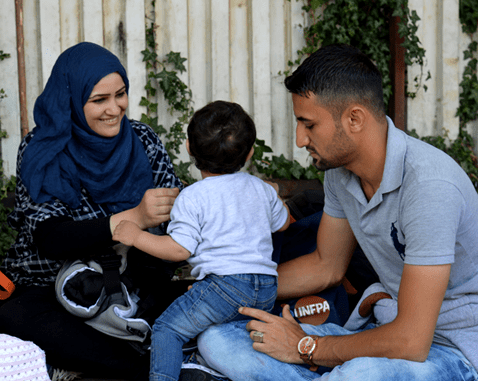 Syrian refugee family in Greece A young Syrian family on the border between Greece and Macedonia.
