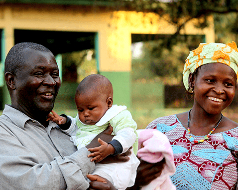 Family in Guinea A mother and father with their baby.