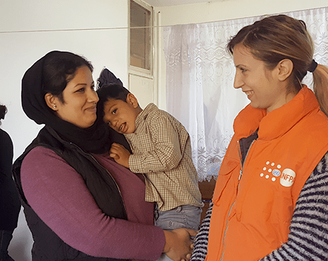Woman, son and UNFPA staff in Serbia A refugee woman and her son meet with UNFPA staff.