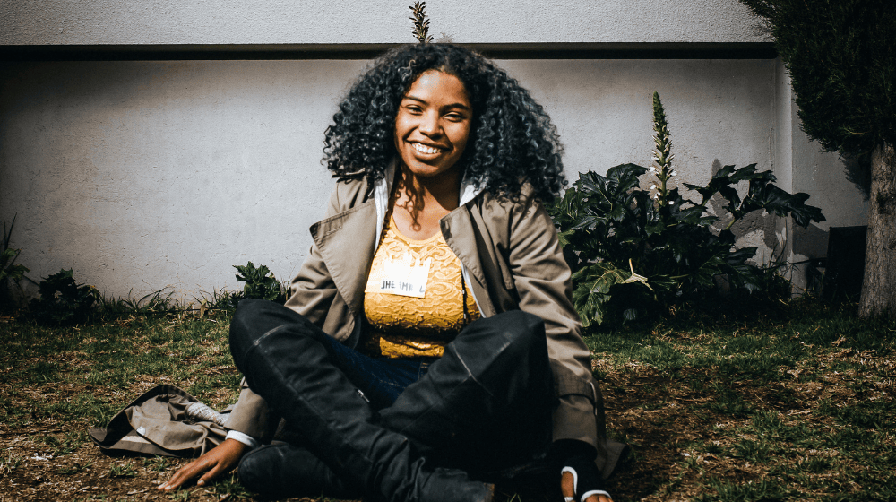 Woman smiles brightly into camera.