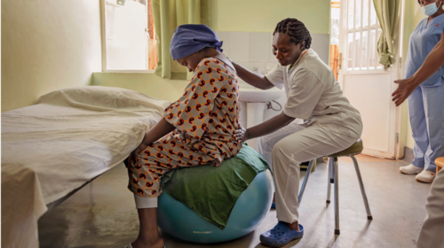 Midwife checks on patient.