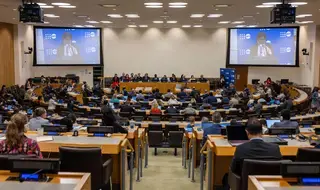 UNFPA Executive Director Ms. Diene Keita stands at a podium and addresses a large audience at an Executive Board meeting.